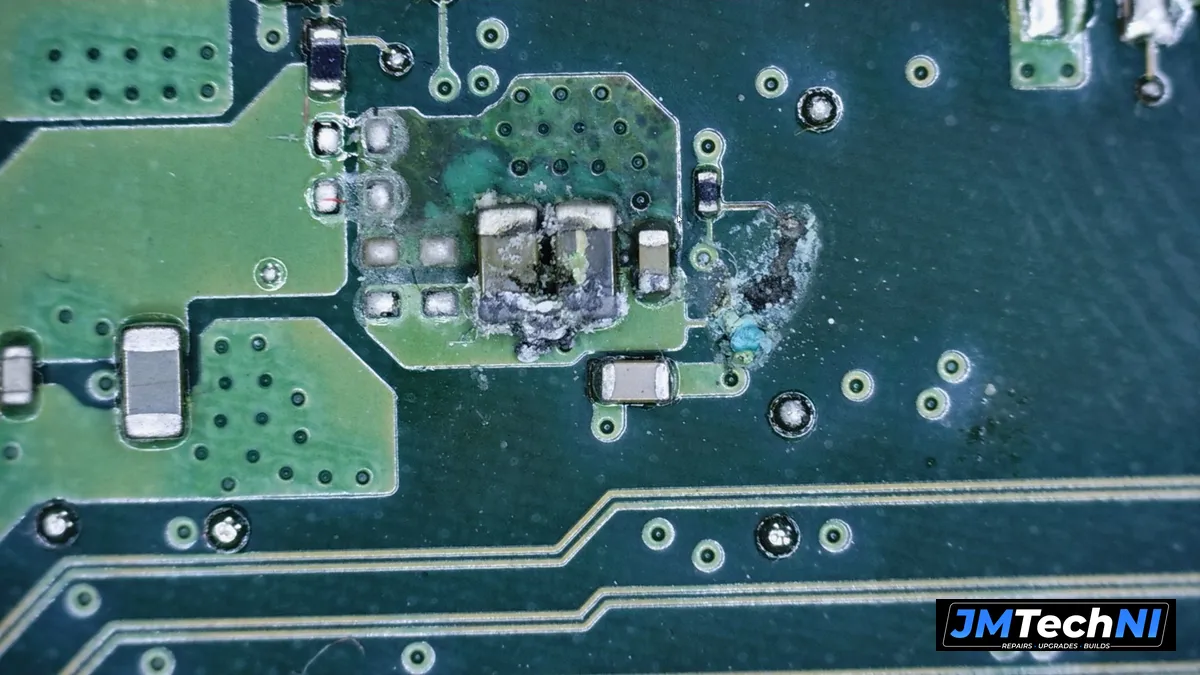 Burnt capacitors on the motherboard under the microscope