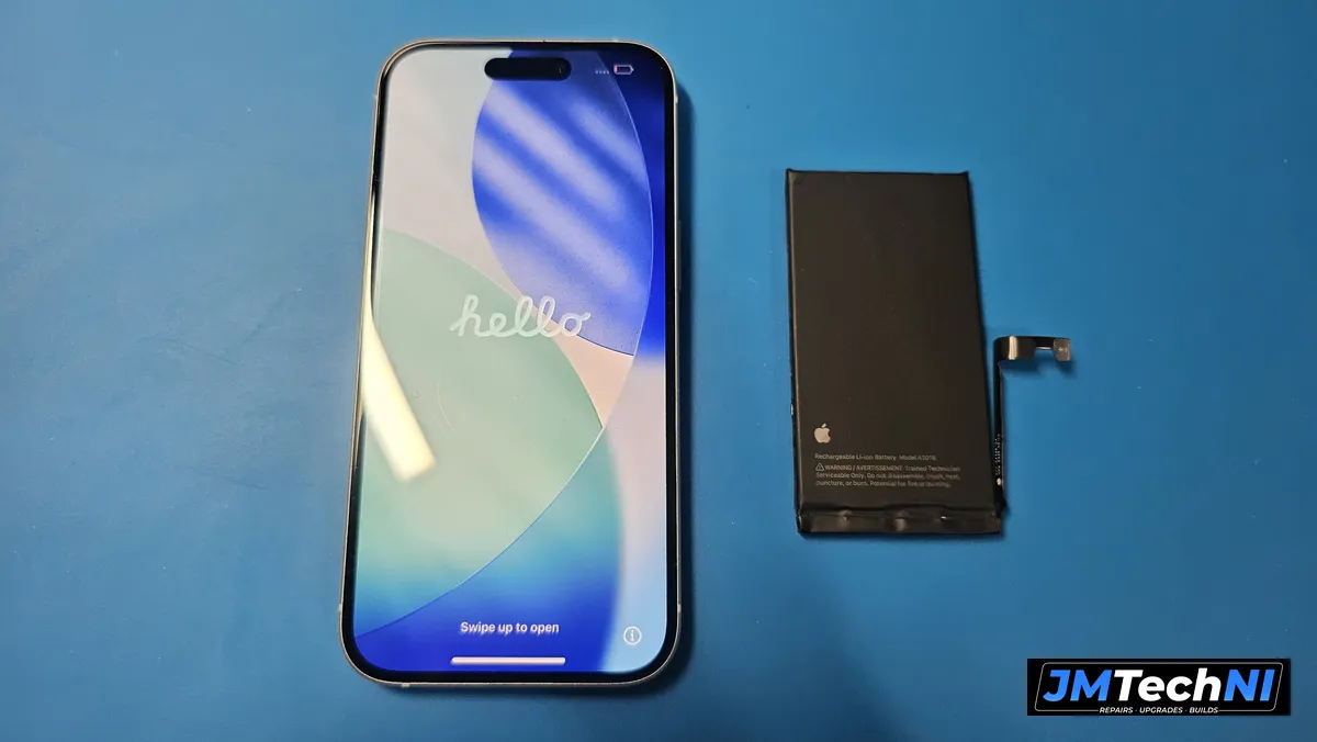iPhone 15 powered up after the repair, with the old battery removed