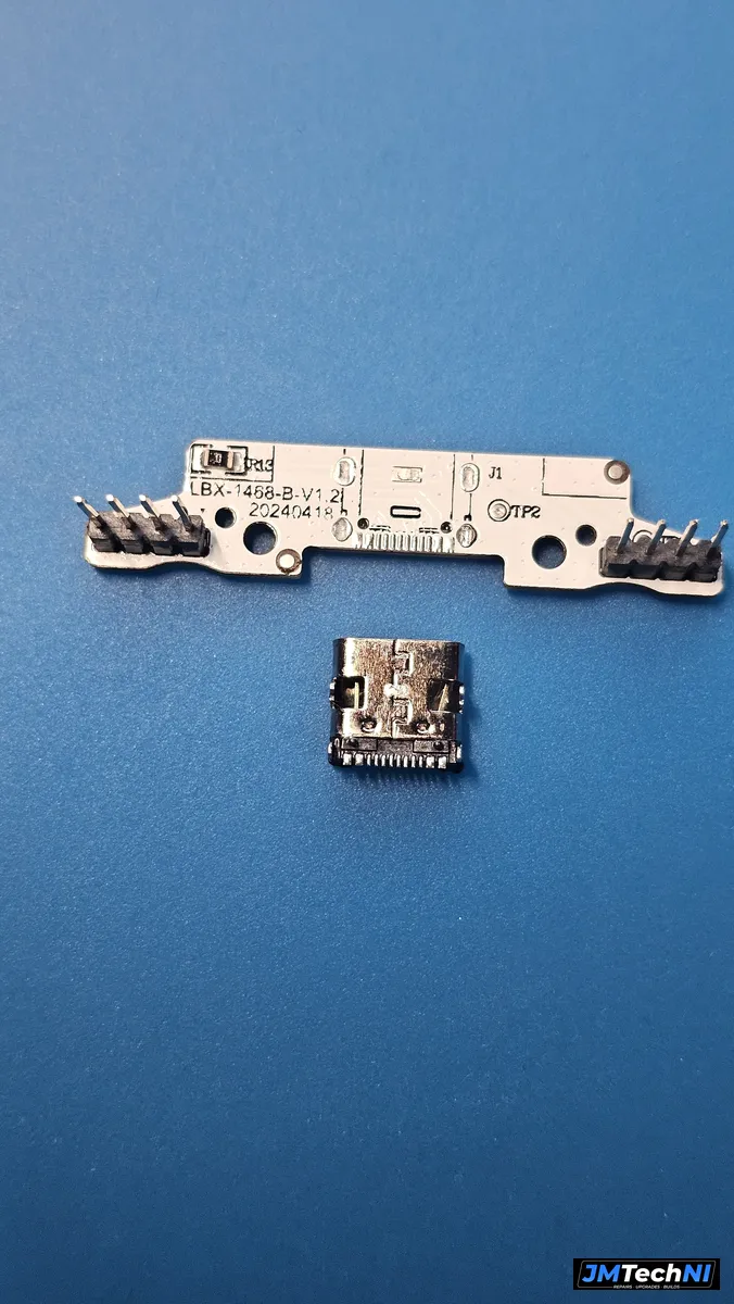 Charging board with the old port removed, new USB-C connector ready to solder